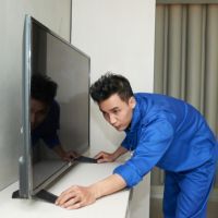 Professional TV repair technician working on modern television in Bengaluru